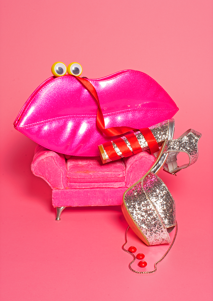 pink bag on pink sofa with silver shoe wrapped in red ribbon - eyes to make it human like - as a surreal image